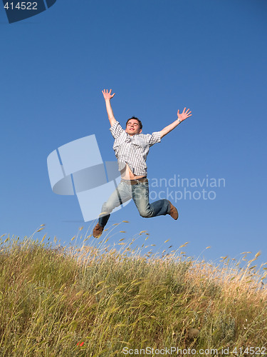 Image of Happy Jumping Teenager Above Hill
