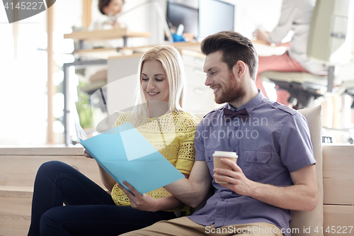 Image of office workers with folder and coffee