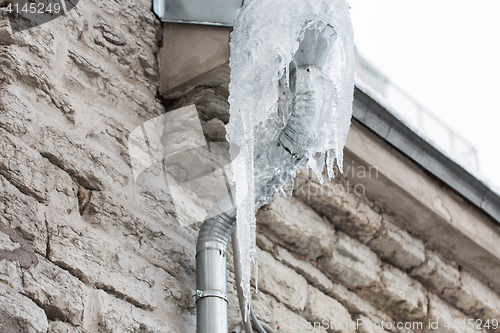 Image of icicles hanging from building drainpipe