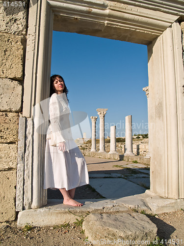 Image of Barefoot Girl Leaning Ancient Ruins