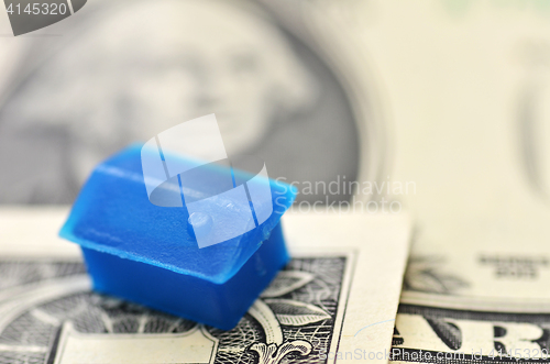 Image of Little plastic house on US dollar banknote