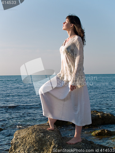 Image of Young Woman on Sea Stone Looking Straight