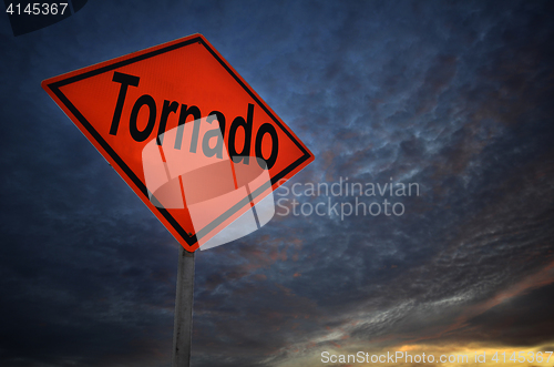 Image of Orange storm road sign of tornado