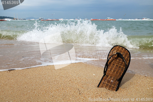 Image of Beach slippers on a sandy beach