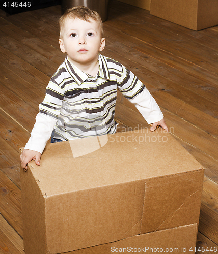 Image of portrait of little cute boy playing with box, lifestyle people concept