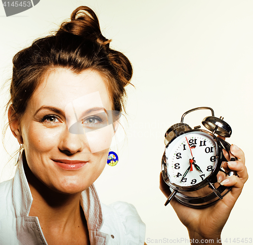 Image of young beauty woman in business style costume waking up for work early morning on white background with clock