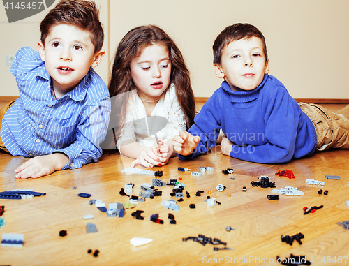 Image of funny cute children playing lego at home, boys and girl smiling, first education role lifestyle