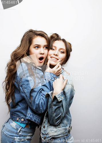 Image of lifestyle and people concept: Fashion portrait of two stylish sexy girls best friends, over white background. Happy time for fun.