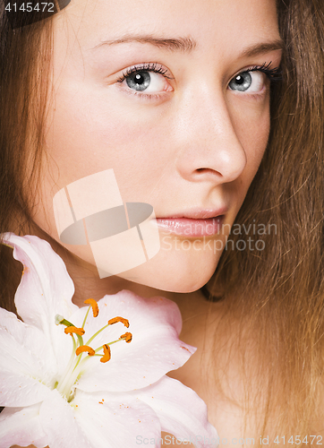 Image of beauty young woman with lily close up, healthcare people concept