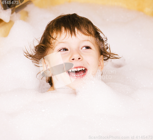 Image of little cute boy in bathroom with bubbles close up