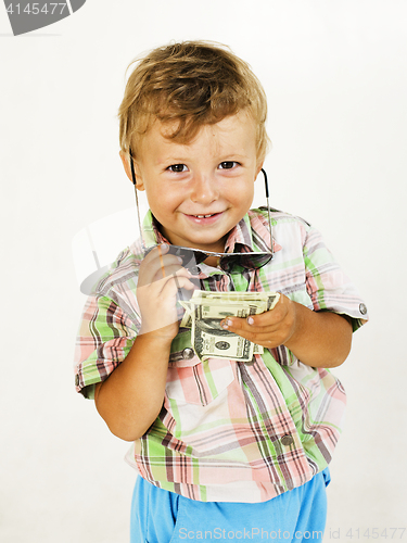 Image of Little boy in sunglasses with money smiling, against white background