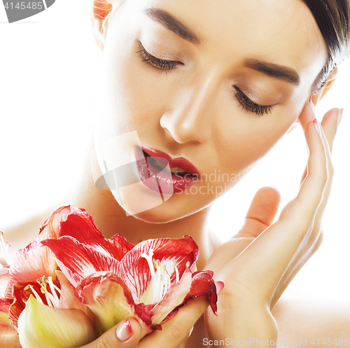 Image of young pretty brunette woman with red flower amaryllis close up i