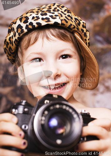 Image of little cute boy in leopard cap and camera, young fashion photographer