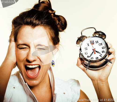 Image of young beauty woman in business style costume waking up for work early morning on white background with clock