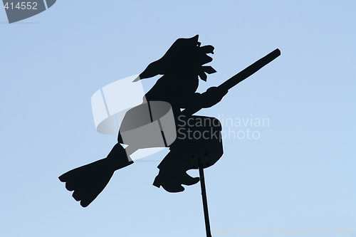 Image of Black witch on the roof.