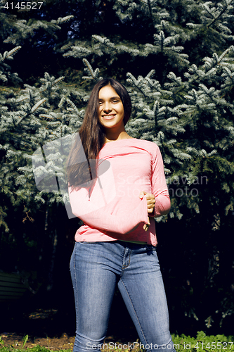 Image of Enjoying the nature. Young woman enjoying the fresh air in green