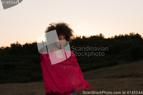 Image of outdoor portrait of a black woman with a scarf