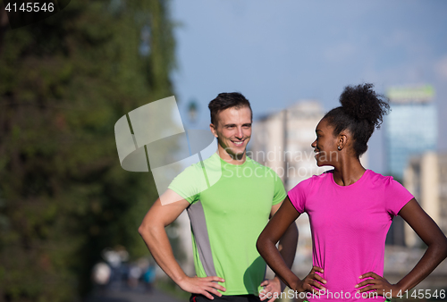 Image of portrait of young multietnic jogging couple ready to run