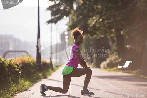 Image of Black woman doing warming up and stretching