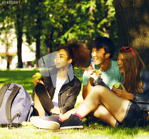 Image of cute group of teenages at the building of university with books 