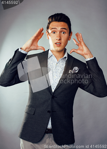 Image of young pretty business man standing on white background, modern hairstyle, posing emotional, lifestyle people concept