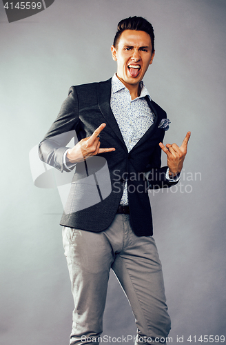 Image of young pretty business man standing on white background, modern hairstyle, posing emotional, lifestyle people concept