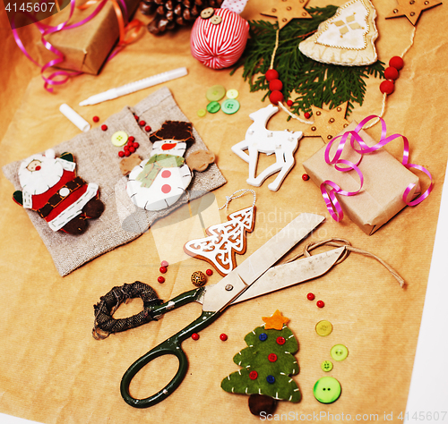 Image of handmade christmas gifts in mess with toys, candles, fir, ribbon wooden vintage