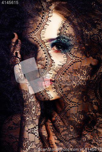 Image of portrait of beauty young woman through lace close up mistery mak