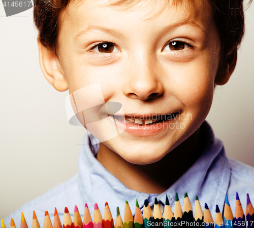 Image of little cute boy with color pencils close up smiling, education f