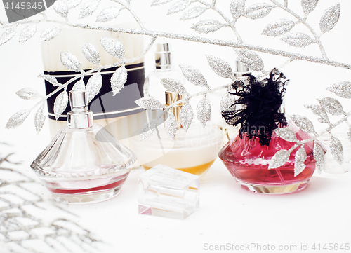 Image of Jewelry table with lot of girl stuff on it, little mess in cosmetic brushes, women interior concept, perfume elegance things