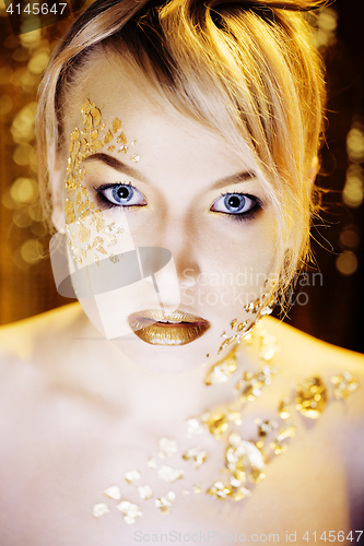 Image of beauty blond woman with gold creative make up