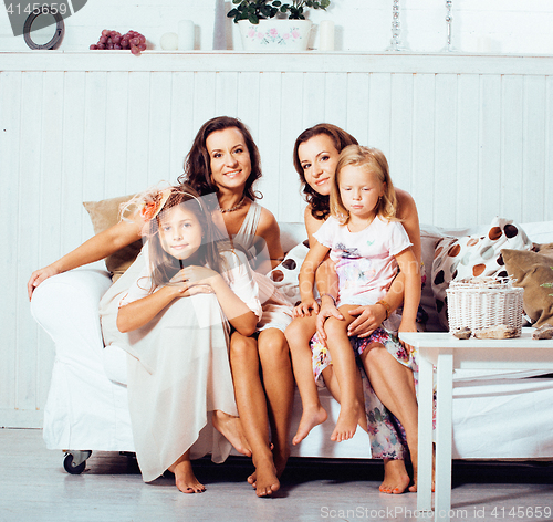 Image of Mature sisters twins at home with little daughter, happy family in interior, lifestyle people concept