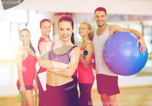 Image of woman standing in front of the group in gym