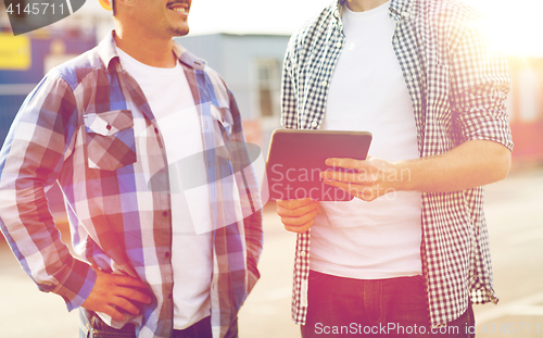 Image of close up of builders with tablet pc outdoors