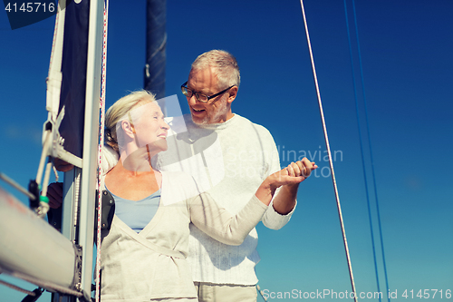 Image of happy senior couple on sail boat or yacht in sea