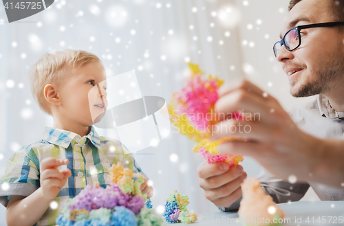 Image of father and son playing with ball clay at home