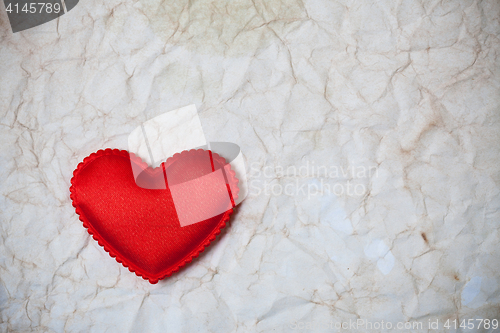 Image of old wrinkled paper background and red hear