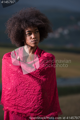 Image of outdoor portrait of a black woman with a scarf