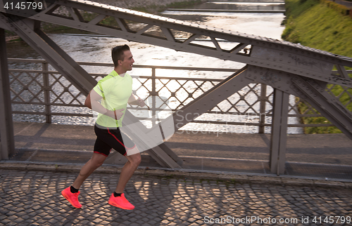 Image of a young man jogging in the city