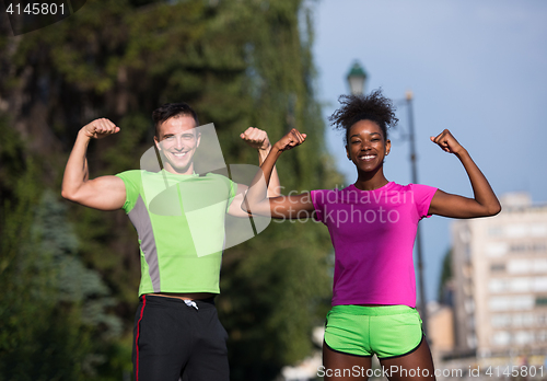 Image of portrait of young multietnic jogging couple ready to run