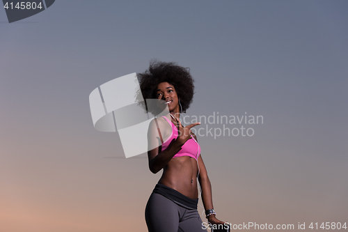 Image of young black girl dances outdoors