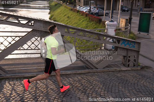 Image of a young man jogging in the city