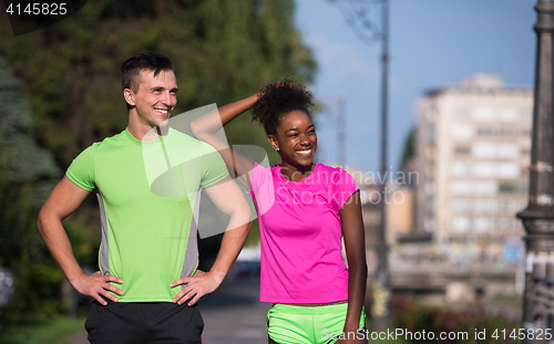 Image of portrait of young multietnic jogging couple ready to run