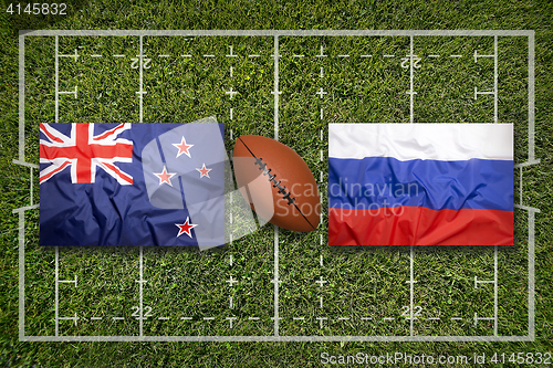 Image of New Zealand vs. Russia flags on rugby field
