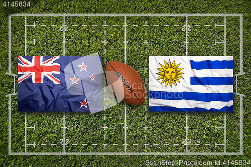 Image of New Zealand vs. Uruguay flags on rugby field