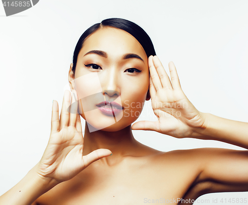 Image of young pretty asian woman with hands on face isolated on white background, stylish fashion healthcare people concept