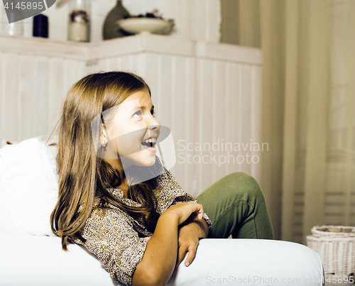 Image of little cute brunette girl at home interior happy smiling close u