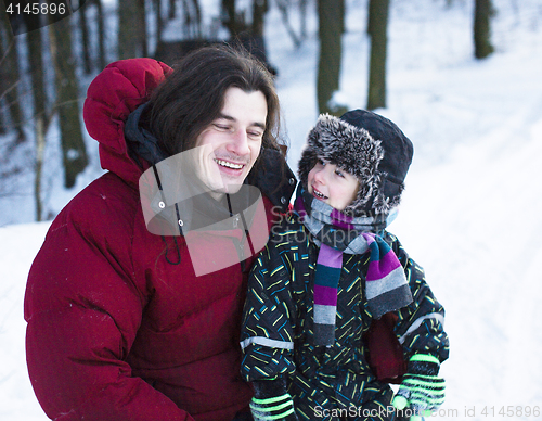 Image of young happy father with his son little cute boy outside in winter park, lifestyle people concept