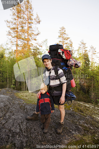 Image of young happy father traveling with little son and huge backpack, lifestyle people concept