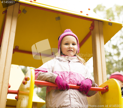 Image of little cute girl playing outside on playground, lifestyle people concept